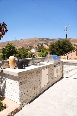 a outdoor view of a swimming pool with a lawn chairs