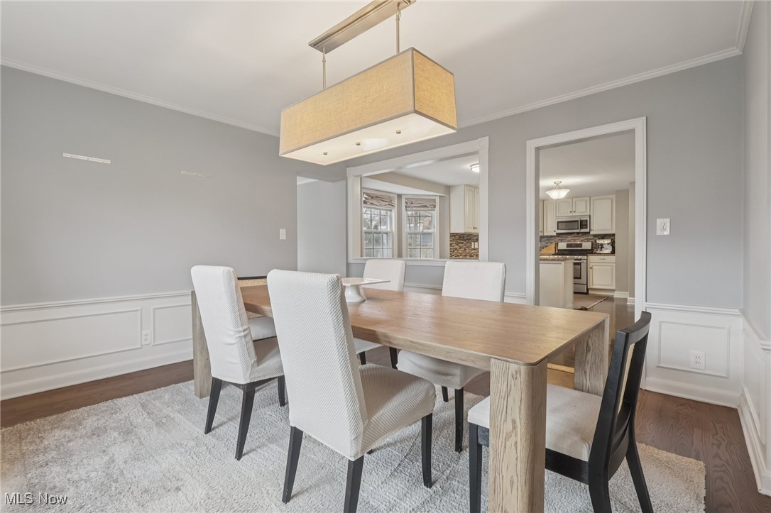 17024 Fernway Road Cleveland, OH 44120 - Photo 15 of 46 Dining Room with wainscoted walls, crown molding, and wood floors