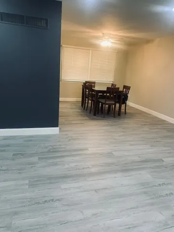 a kitchen with a refrigerator stove and wooden floor