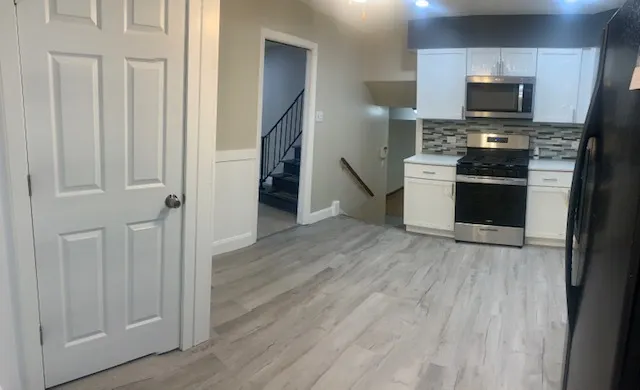 a view of a elevator with wooden floor