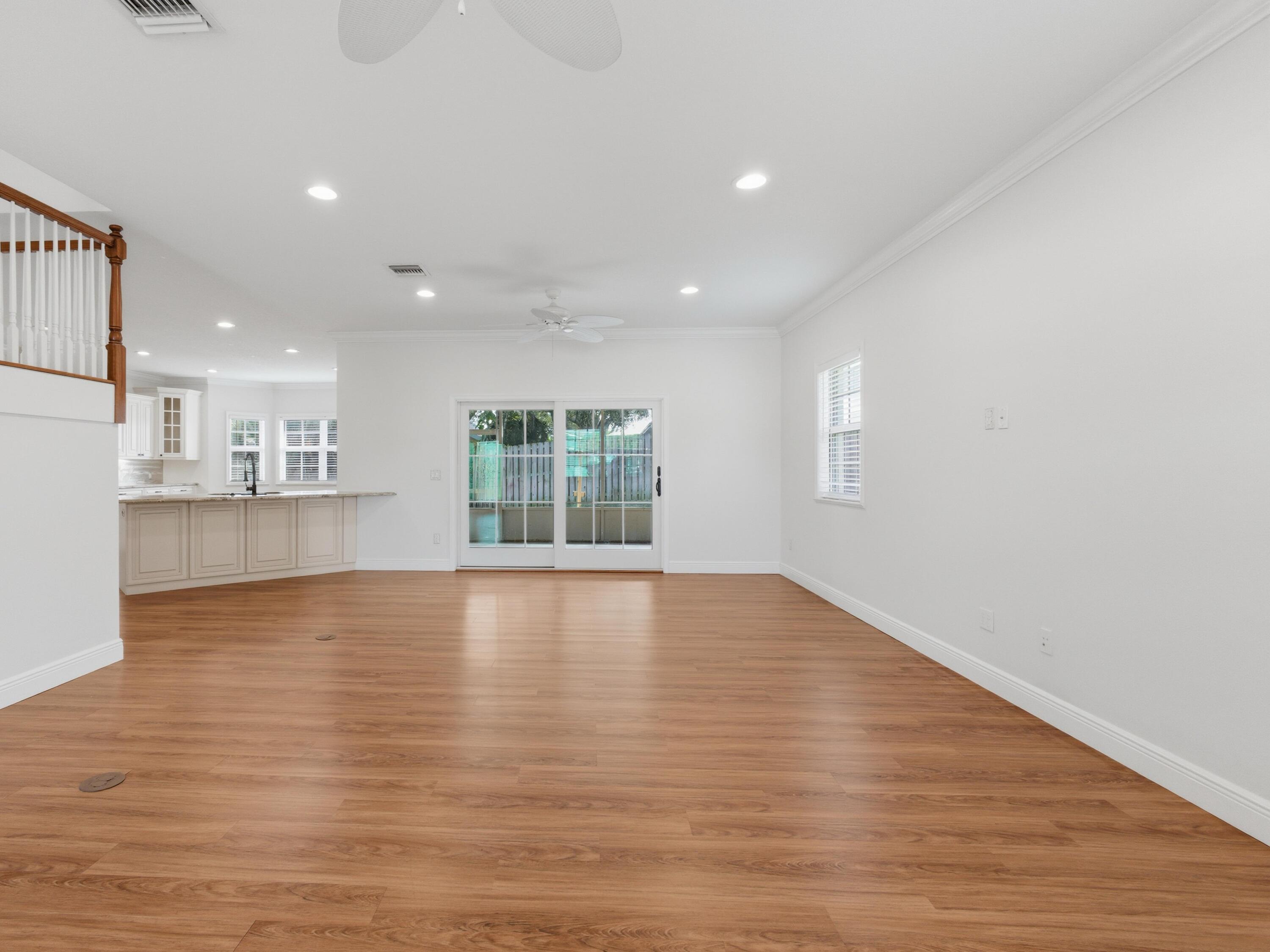 9322 Southeast Athena Street Hobe Sound, FL 33455 - Photo 12 of 69 a view of an empty room with wooden floor and a window