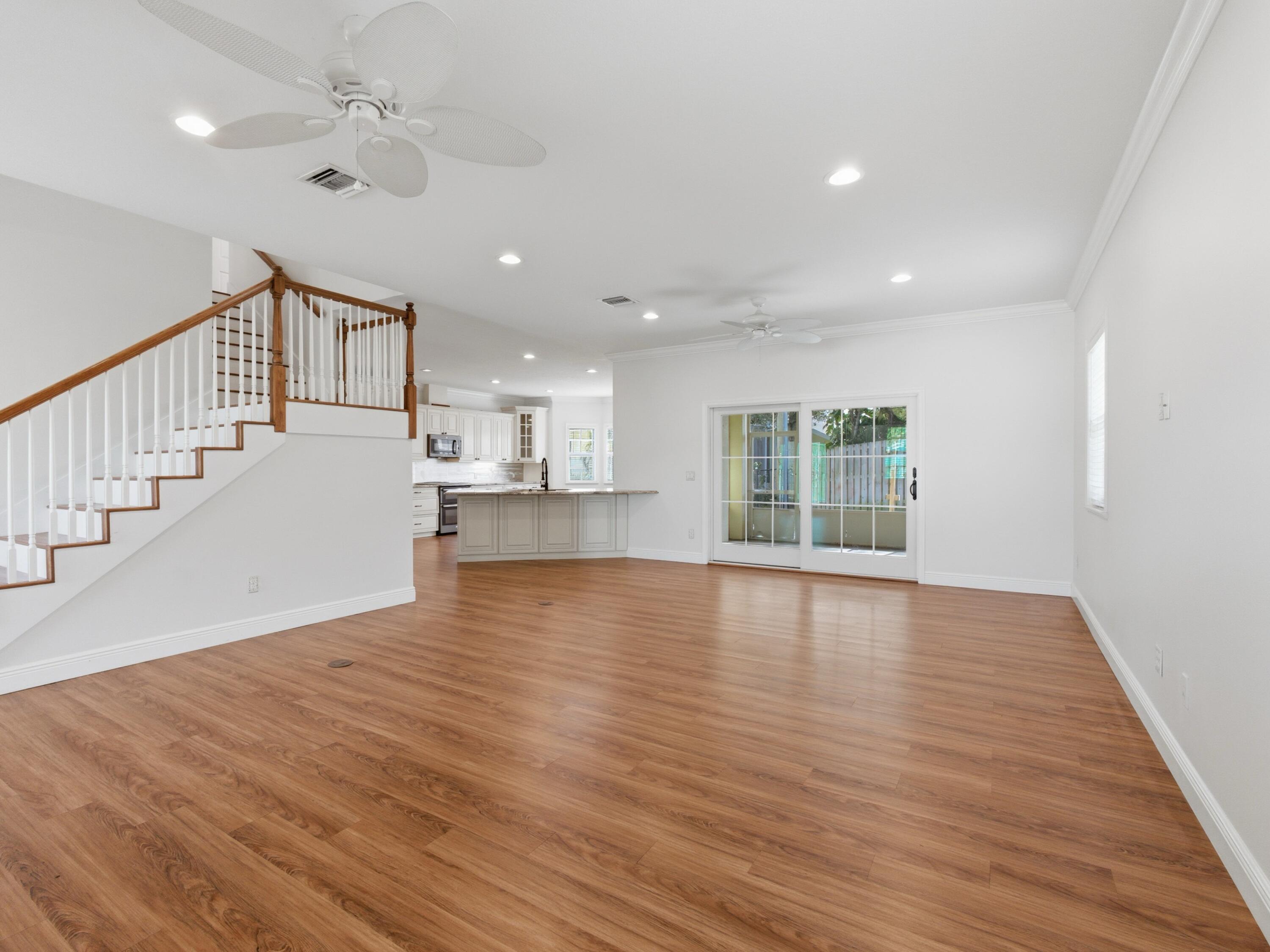 9322 Southeast Athena Street Hobe Sound, FL 33455 - Photo 13 of 69 a view of an empty room with wooden floor and a window