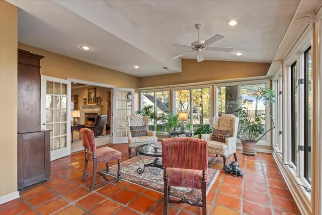 a living room with furniture and a floor to ceiling window