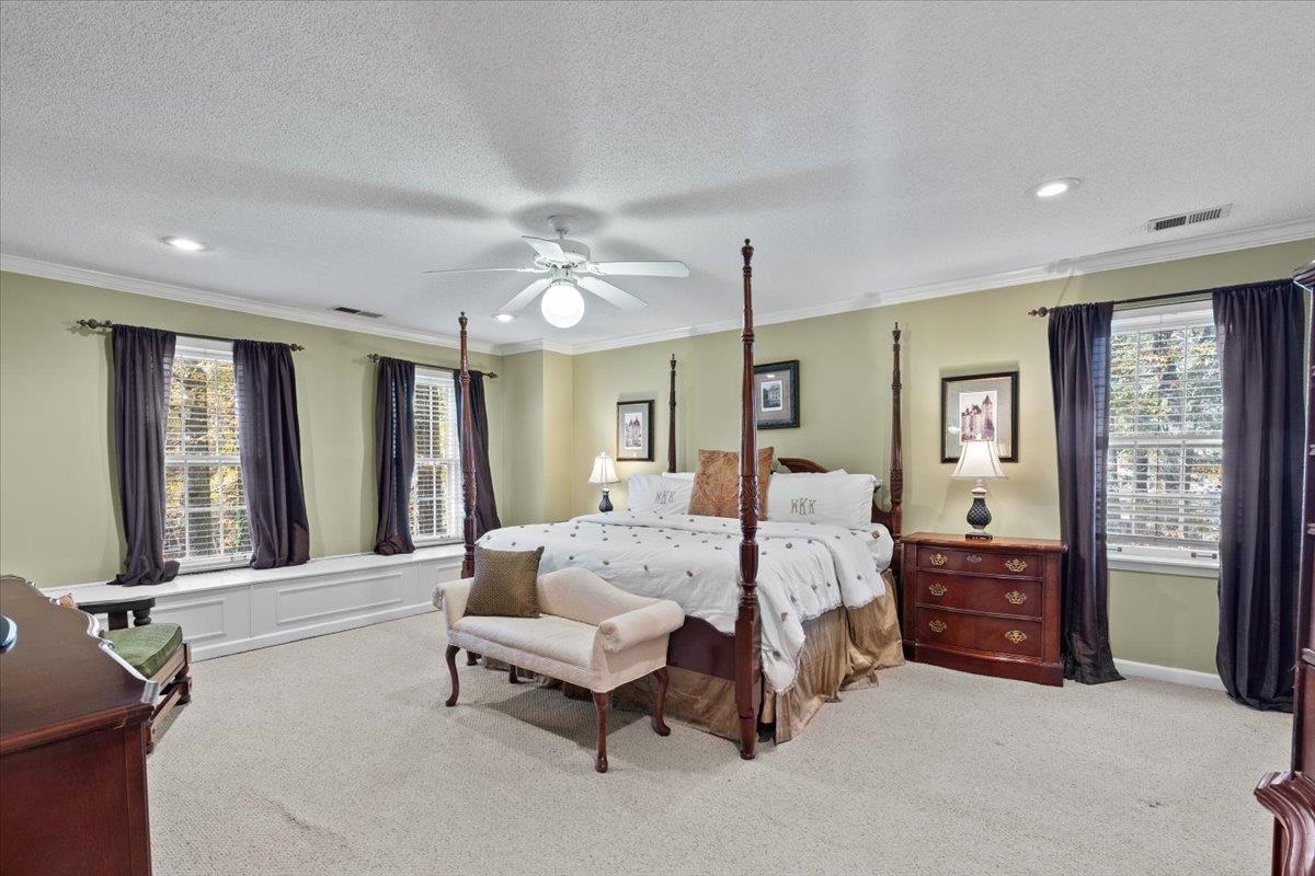 732 North Tree Drive Collierville, TN 38017 - Photo 23 of 40 Bedroom with crown molding, light carpet, multiple windows, a textured ceiling, and a ceiling fan