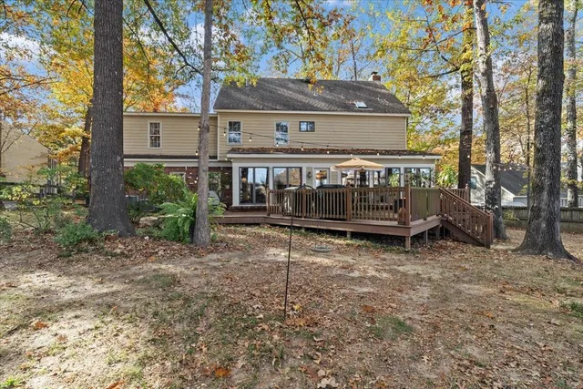 a view of backyard with deck and garden