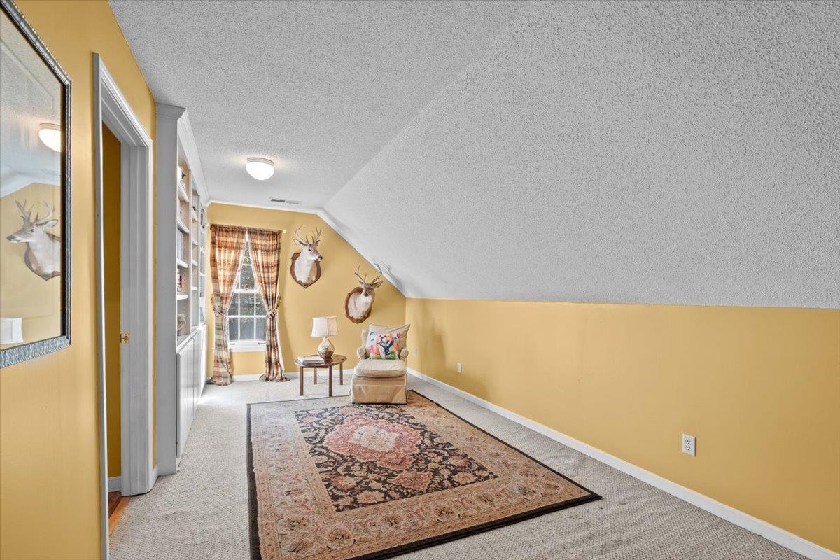 732 North Tree Drive Collierville, TN 38017 - Photo 31 of 40 Sitting room featuring a textured ceiling, lofted ceiling, and carpet