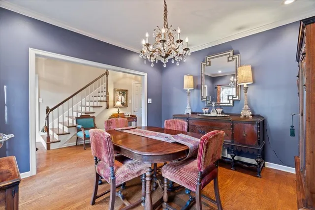a view of a dining room with furniture and a chandelier