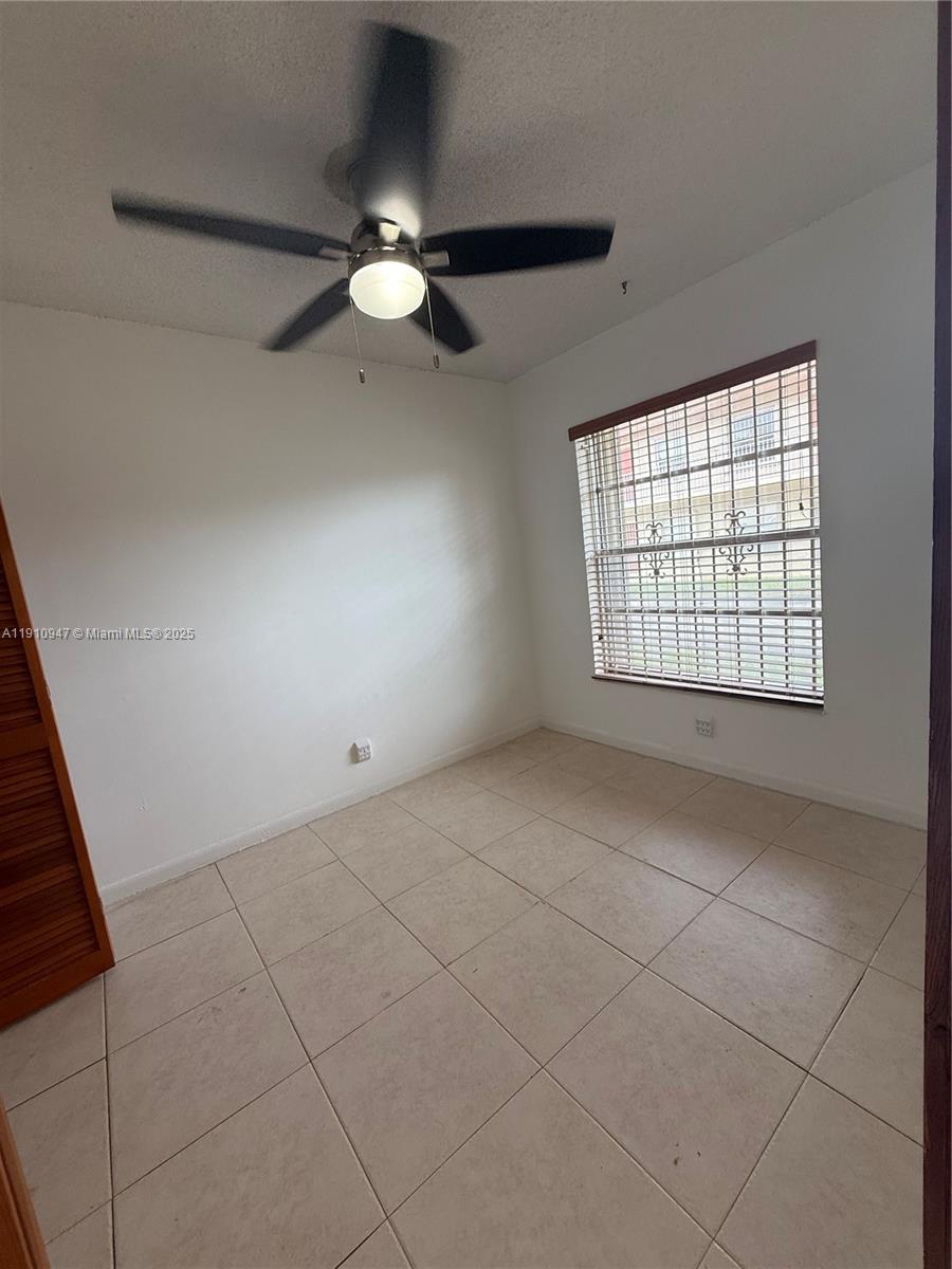 12810 Southwest 43rd Drive, Unit 115B Miami, FL 33175 - Photo 14 of 22 a view of an empty room with a window