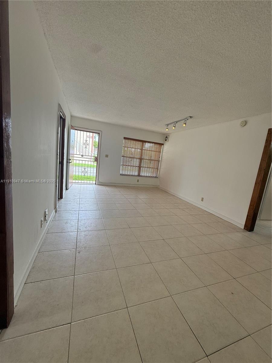 12810 Southwest 43rd Drive, Unit 115B Miami, FL 33175 - Photo 15 of 22 a view of an empty room and window