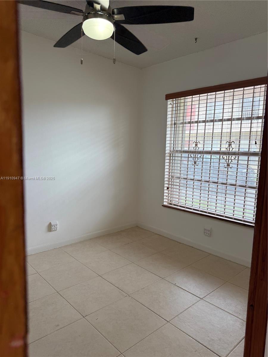 12810 Southwest 43rd Drive, Unit 115B Miami, FL 33175 - Photo 16 of 22 an empty room with windows