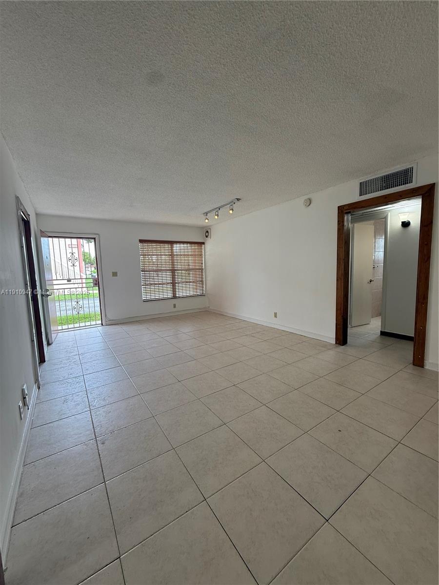 12810 Southwest 43rd Drive, Unit 115B Miami, FL 33175 - Photo 18 of 22 a view of an empty room with a window