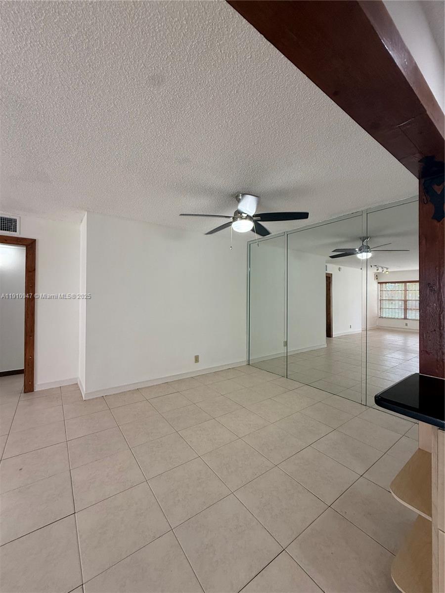12810 Southwest 43rd Drive, Unit 115B Miami, FL 33175 - Photo 19 of 22 a view of a livingroom with a ceiling fan and window