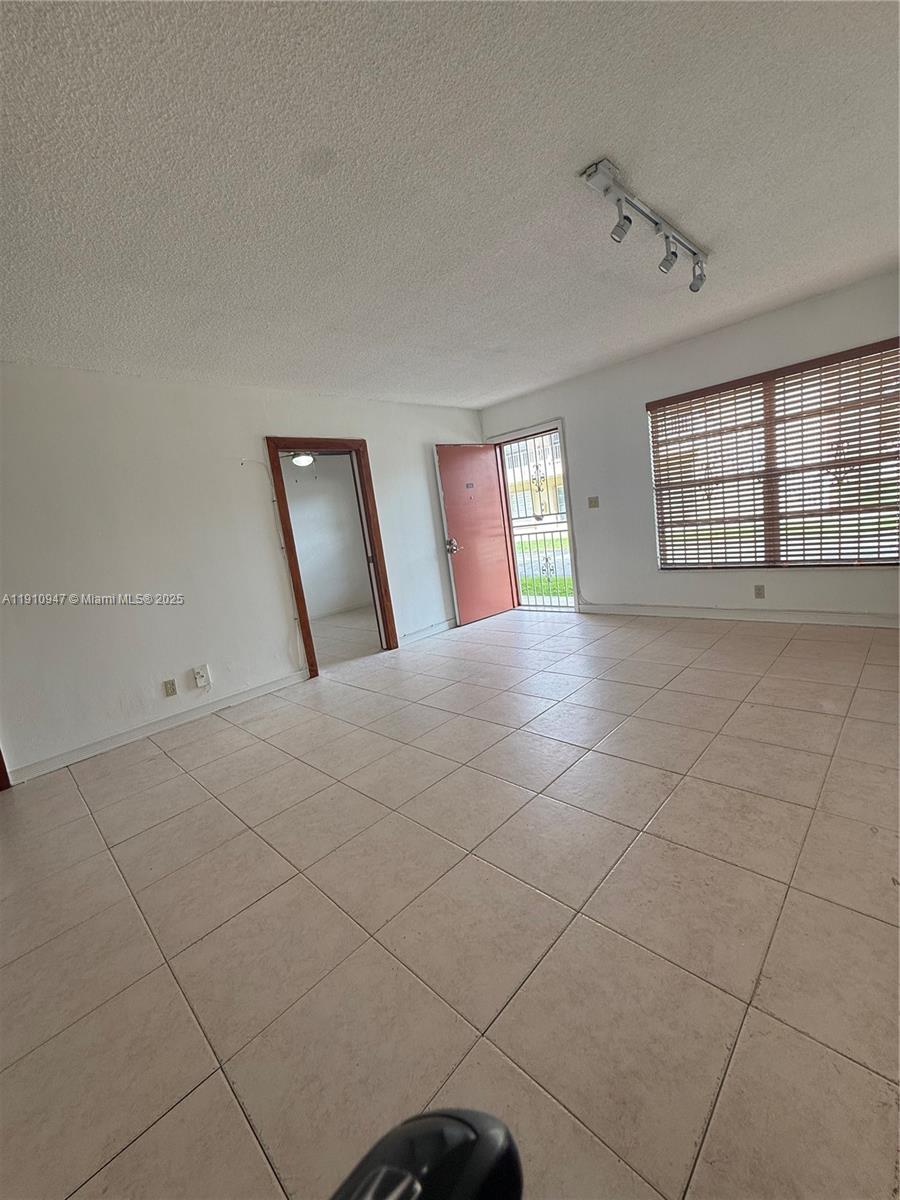 12810 Southwest 43rd Drive, Unit 115B Miami, FL 33175 - Photo 20 of 22 a view of an empty room with a window