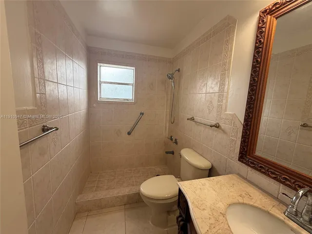 a bathroom with a toilet sink and shower
