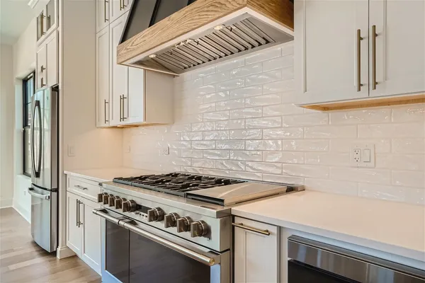 a stove top oven sitting inside of a kitchen