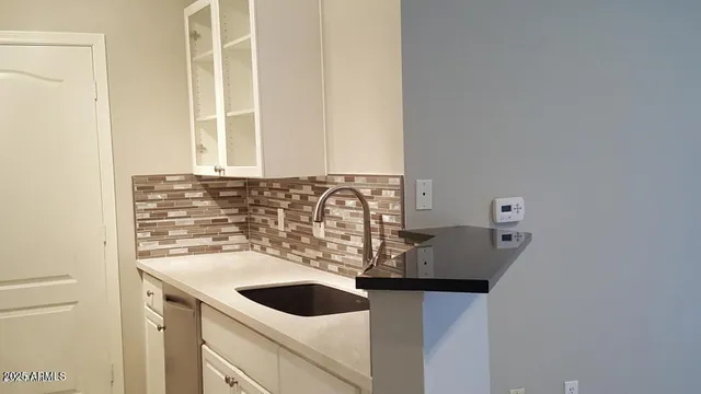 a sink with a stove and cabinets