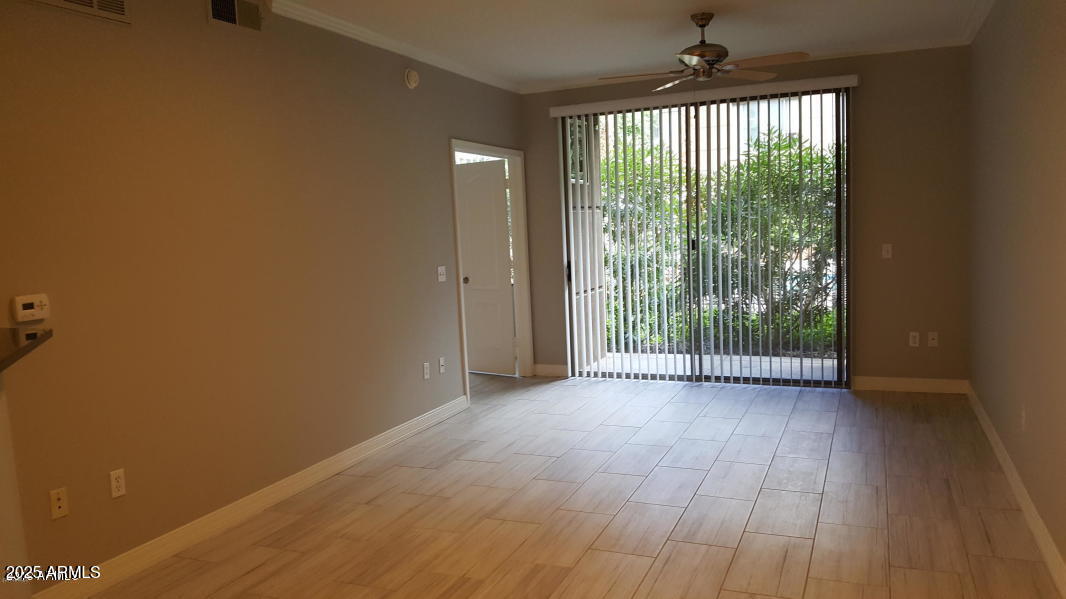 1701 East Colter Street, Unit 153 Phoenix, AZ 85016 - Photo 5 of 11 a view of a room with wooden floor and a window