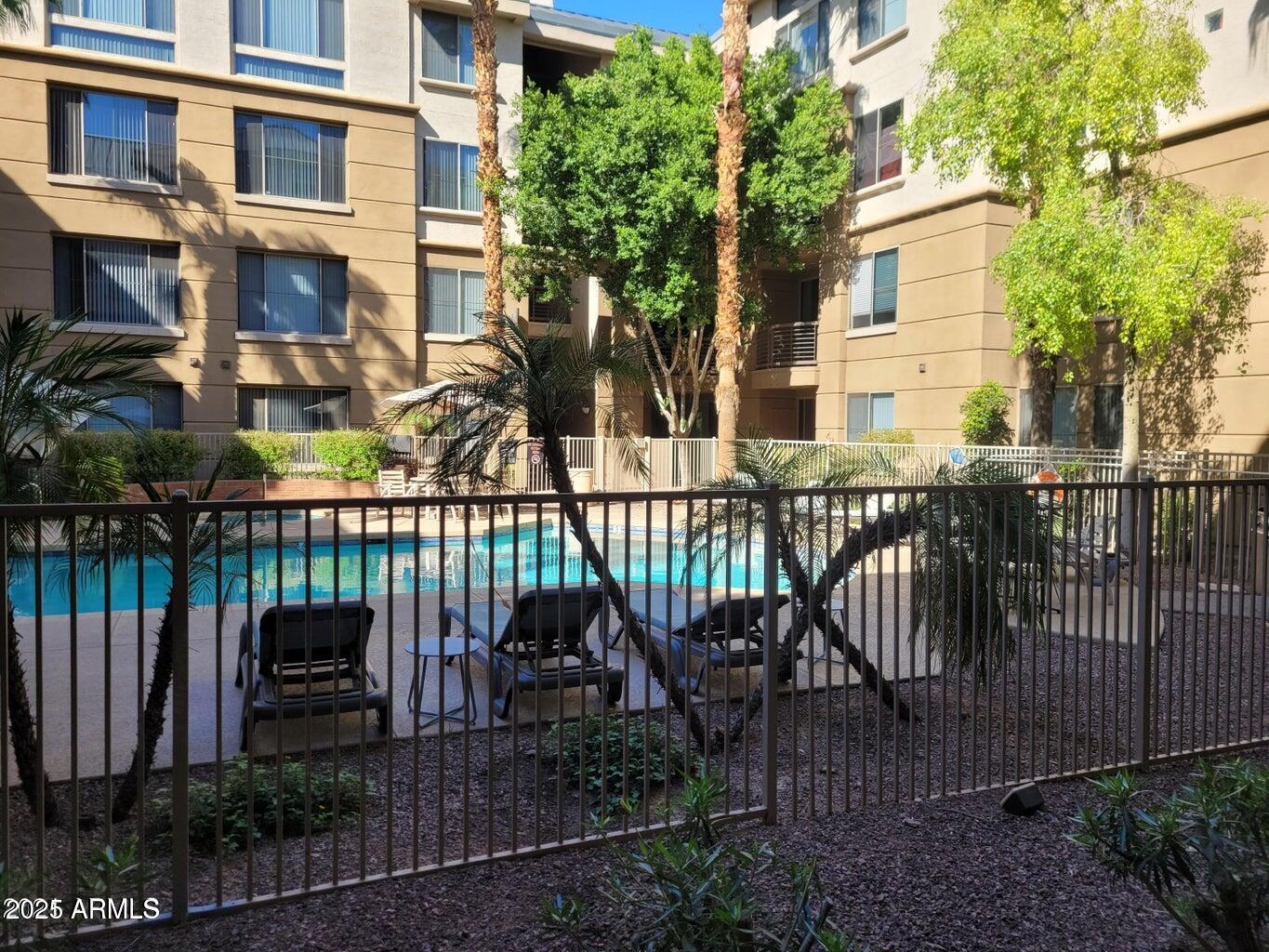 1701 East Colter Street, Unit 153 Phoenix, AZ 85016 - Photo 10 of 11 a view of a chair and table in the patio