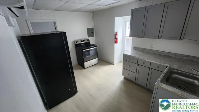 a kitchen with stainless steel appliances a refrigerator and a counter top