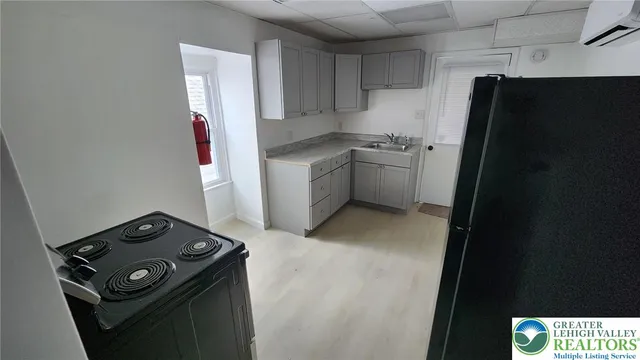 a kitchen with a refrigerator and a stove