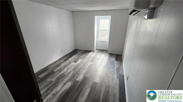 a view of an empty room and wooden floor