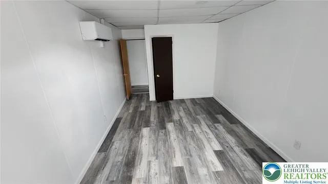 a view of a room with wooden floor