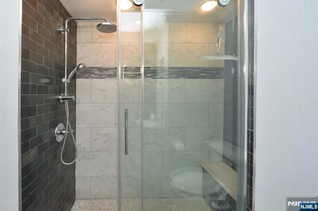 a bathroom with a shower and a sink