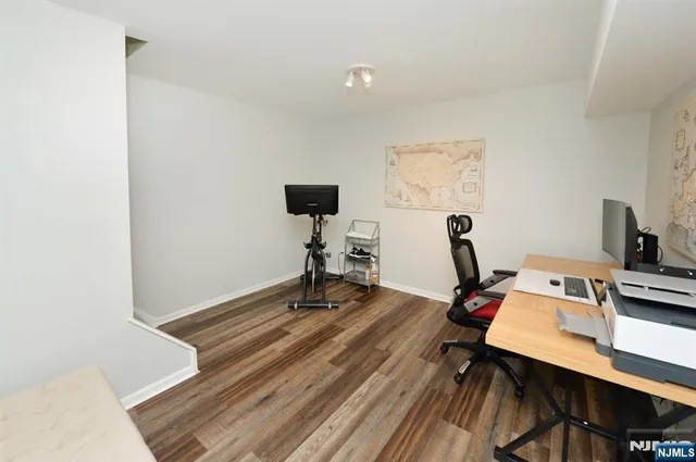 a view of a workspace with furniture and wooden floor