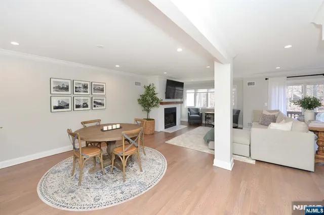 a dining room with furniture a kitchen and chandelier