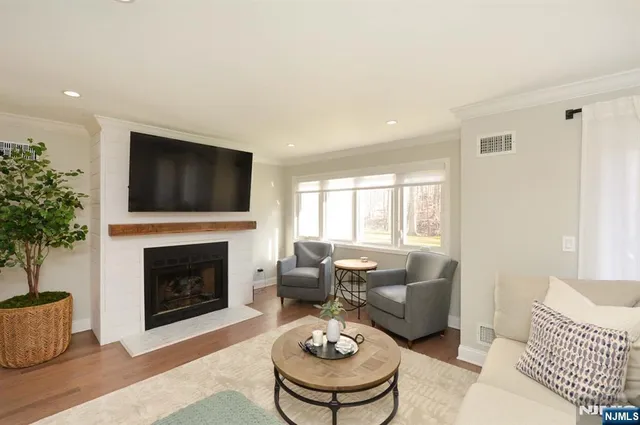 a living room with furniture a fireplace and a flat screen tv
