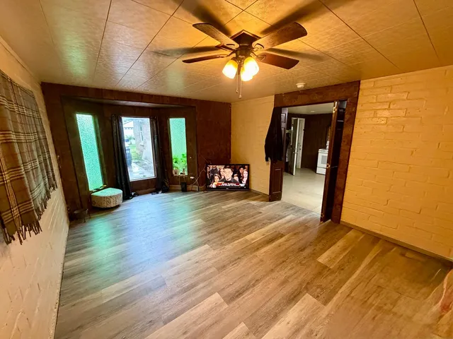 a view of an entryway with wooden floor
