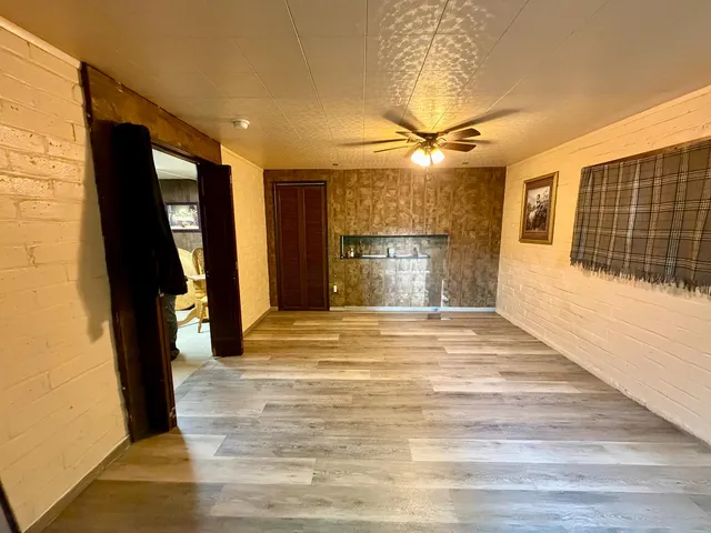 a view of empty room with a fireplace and chandelier