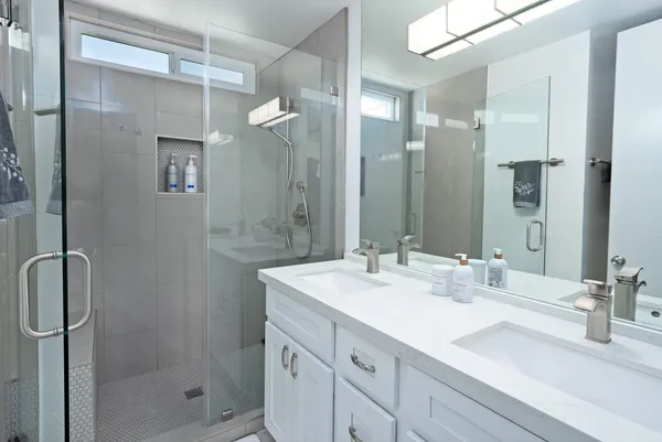 a bathroom with a shower sink vanity granite and shower