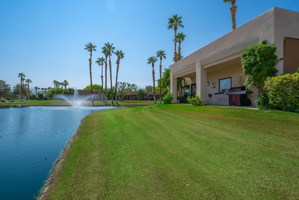 a view of a house with a yard and a patio