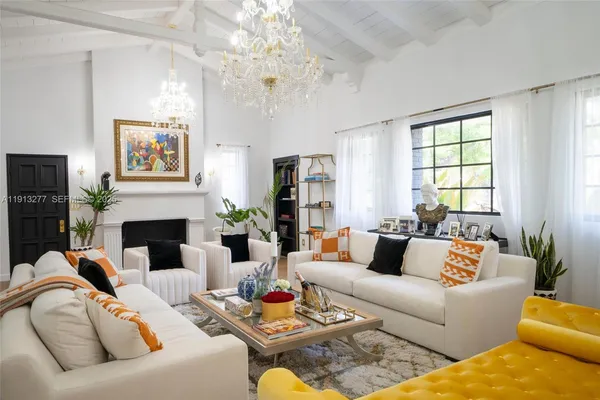 a living room with furniture fireplace and window