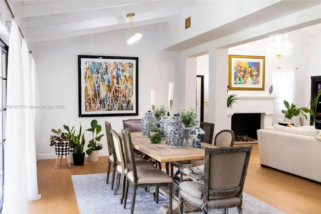 a dining room with furniture potted plants and wooden floor