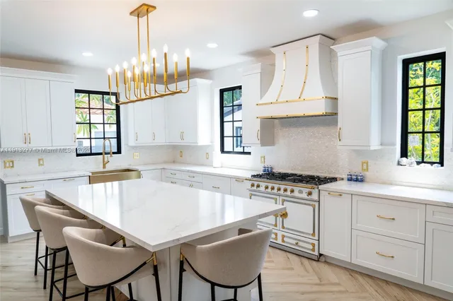 a kitchen with a stove a sink and cabinets
