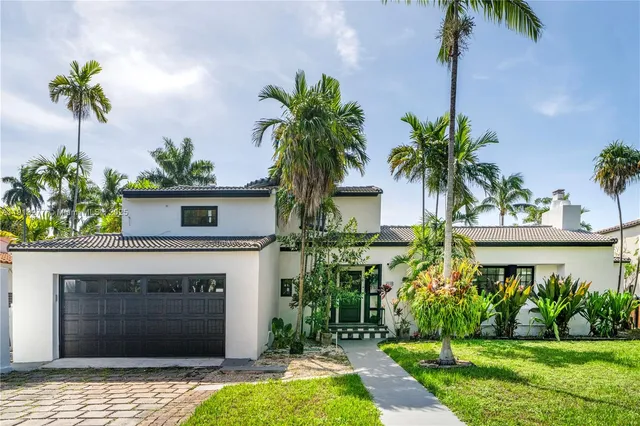 a front view of a house with a yard and a garage