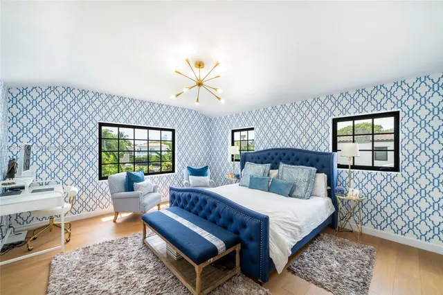 a bedroom with a bed a couch and dresser