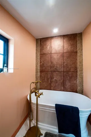 a bathroom with a bathtub and a shower