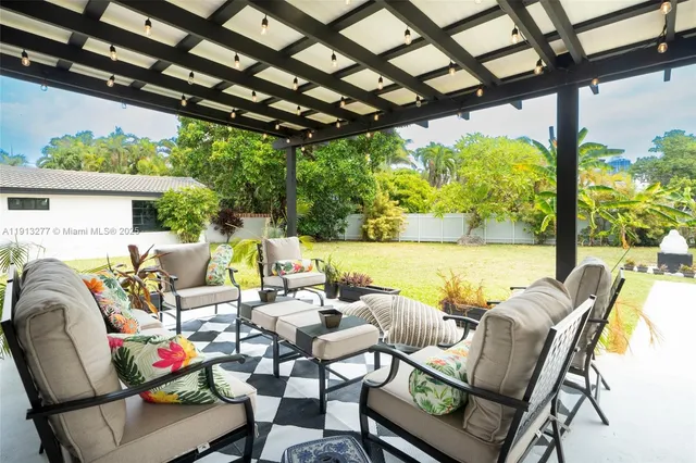 a building outdoor space with patio furniture and garden view