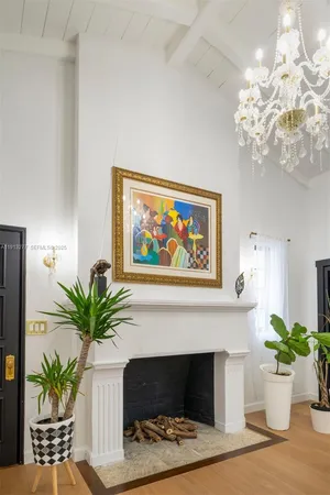 a living room with a fireplace and a potted plant