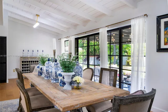 a dining room with furniture window and wooden floor