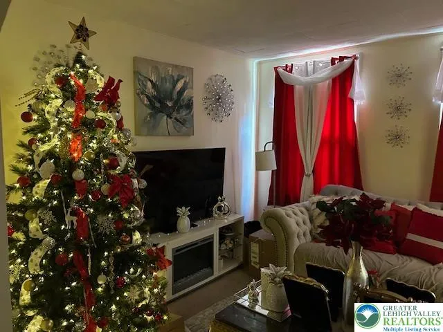 a living room with furniture a flat screen tv and a fireplace
