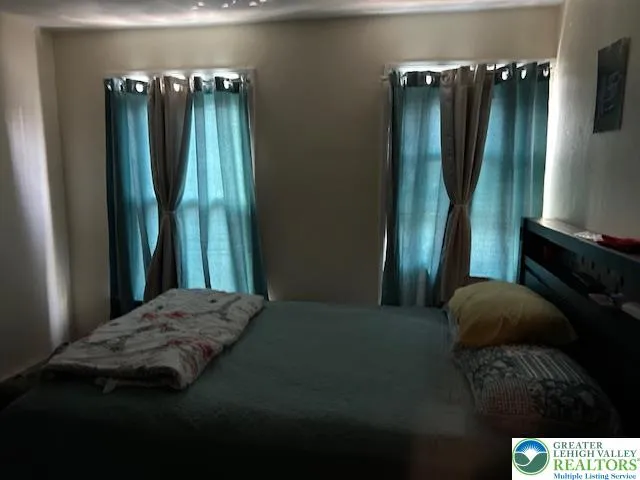 a bedroom with a bed and a mirror