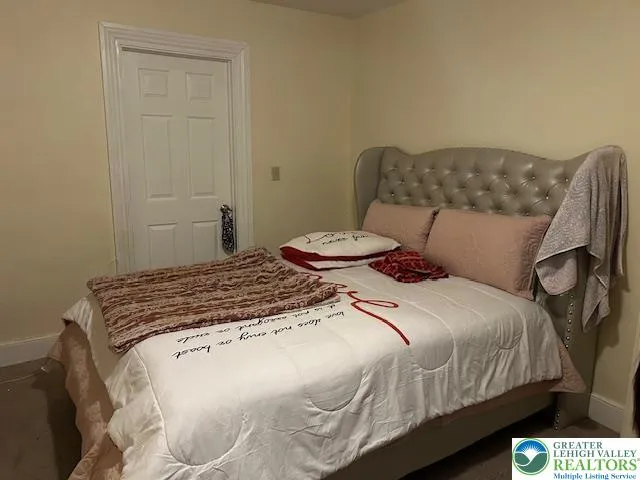 a bedroom with a bed and flowerpot