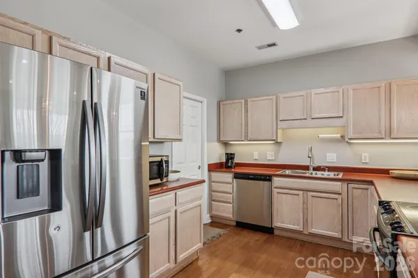 a kitchen with stainless steel appliances a refrigerator sink and cabinets
