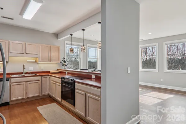 a kitchen with stainless steel appliances granite countertop a stove and a sink
