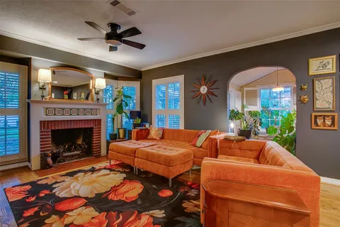 a living room with furniture a fireplace and a chandelier