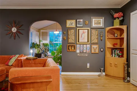 a living room with furniture a fireplace and a potted plant